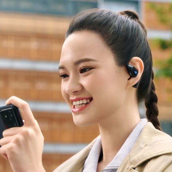 Woman wearing ASUS ROG Cetra Open Gaming Wireless Earbuds