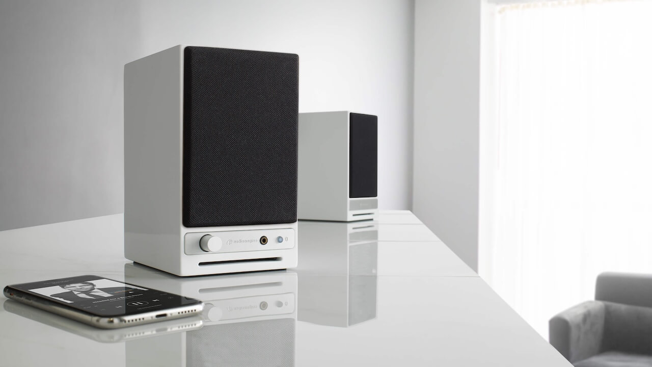 Audioengine HD3 Next Gen Wireless Desktop Speakers in White Lifestyle with phone