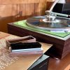 Ramar brush on record cover with Lenco L70 turntable in the background.