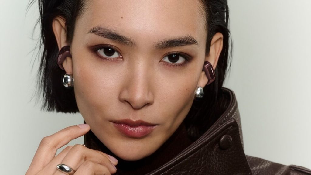 Woman wearing 2026 Bose Ultra Open Earbuds 2nd Gen in cherry chocolate color
