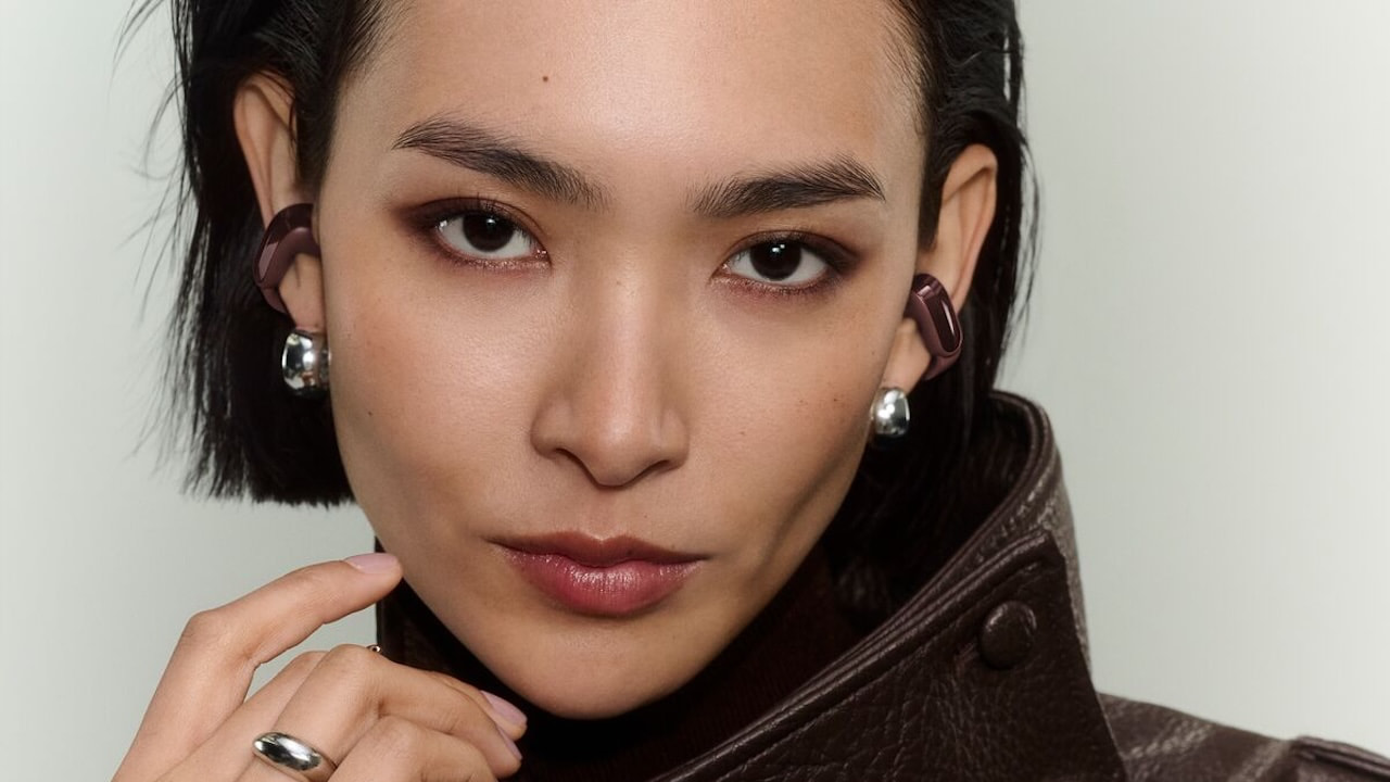 Woman wearing 2026 Bose Ultra Open Earbuds 2nd Gen in cherry chocolate color