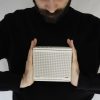 ELAC NAVA100 Adsum Portable Bluetooth Speaker in White in hands