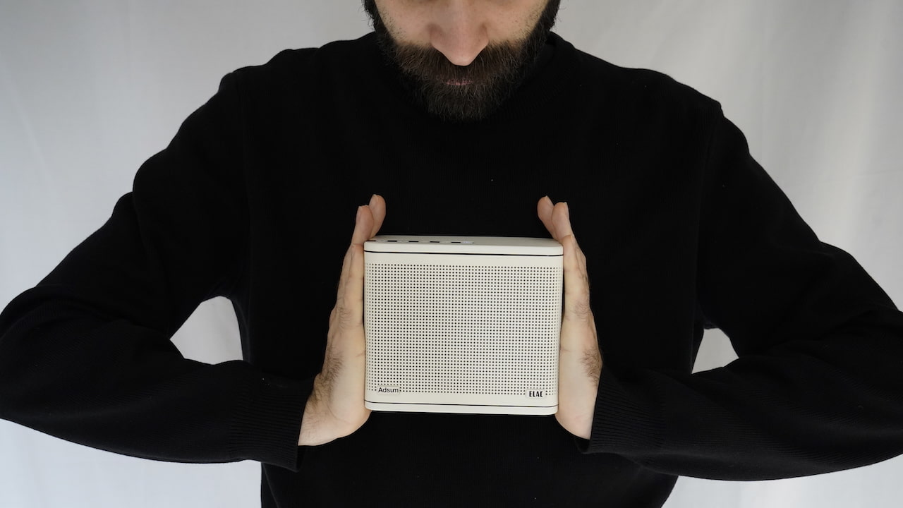 ELAC NAVA100 Adsum Portable Bluetooth Speaker in White in hands