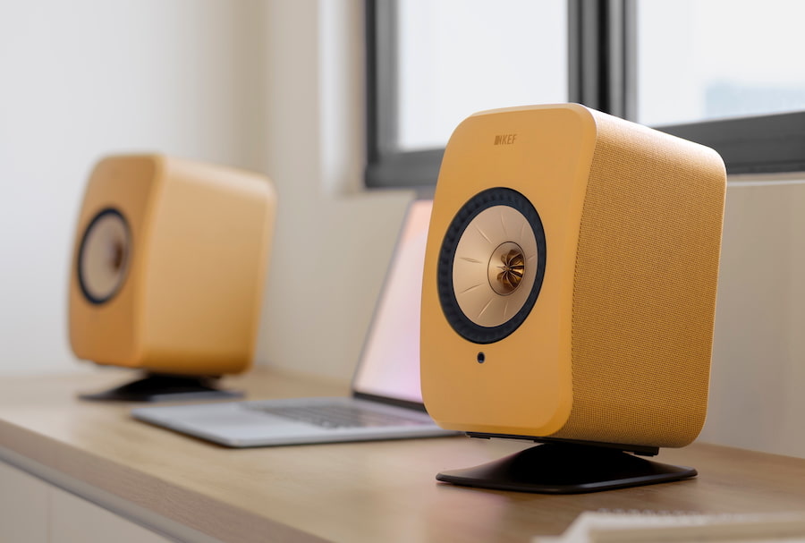 KEF LSX II Wireless Speakers Amber Haze Front Angle with Laptop